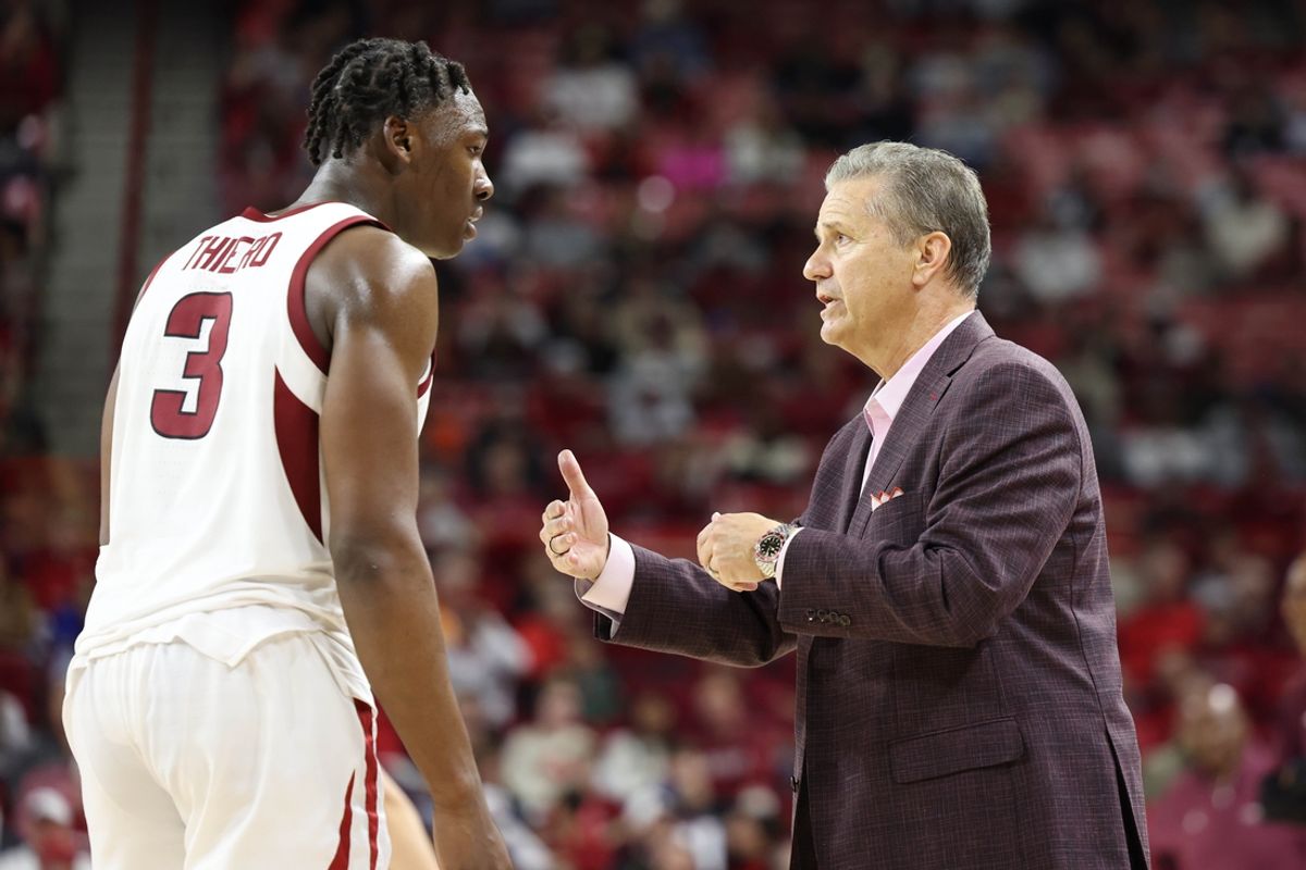 Nov 22, 2024; Fayetteville, Arkansas, USA; Arkansas Razorbacks head coach John Calipari talks to forward Adou Thiero (3) during the second half against the Little Rock Trojans at Bud Walton Arena. Arkansas won 79-67. Mandatory Credit: Nelson Chenault-Imagn Images