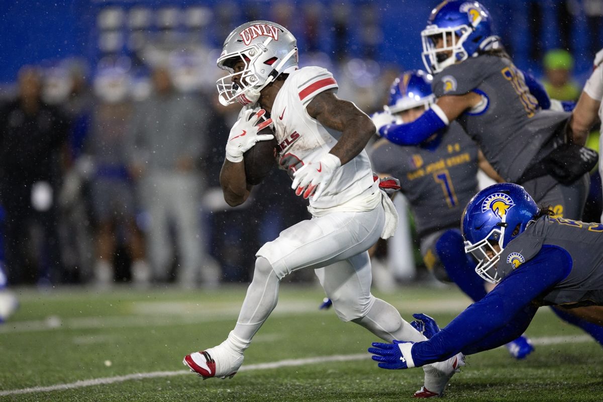 Nov 22, 2024; San Jose, California, USA; UNLV Rebels running back Jai'Den Thomas (9) looks for running room against the San Jose State Spartans during the second quarter at CEFCU Stadium. Mandatory Credit: D. Ross Cameron-Imagn Images