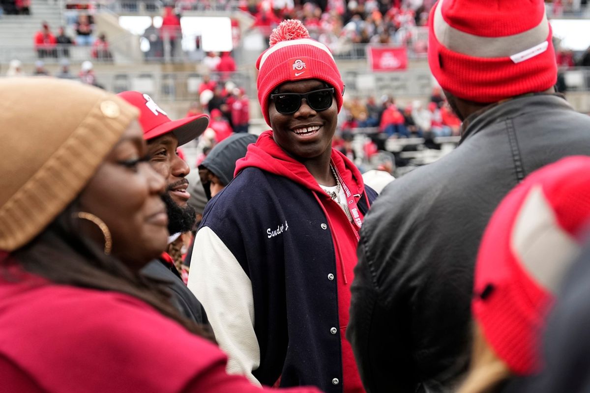 Providence Day School offensive tackle David Sanders Jr. talks to Maurice Clarett, left, prior to the NCAA football game between the Ohio State Buckeyes and the Indiana Hoosiers at Ohio Stadium in Columbus on Saturday, Nov. 23, 2024.