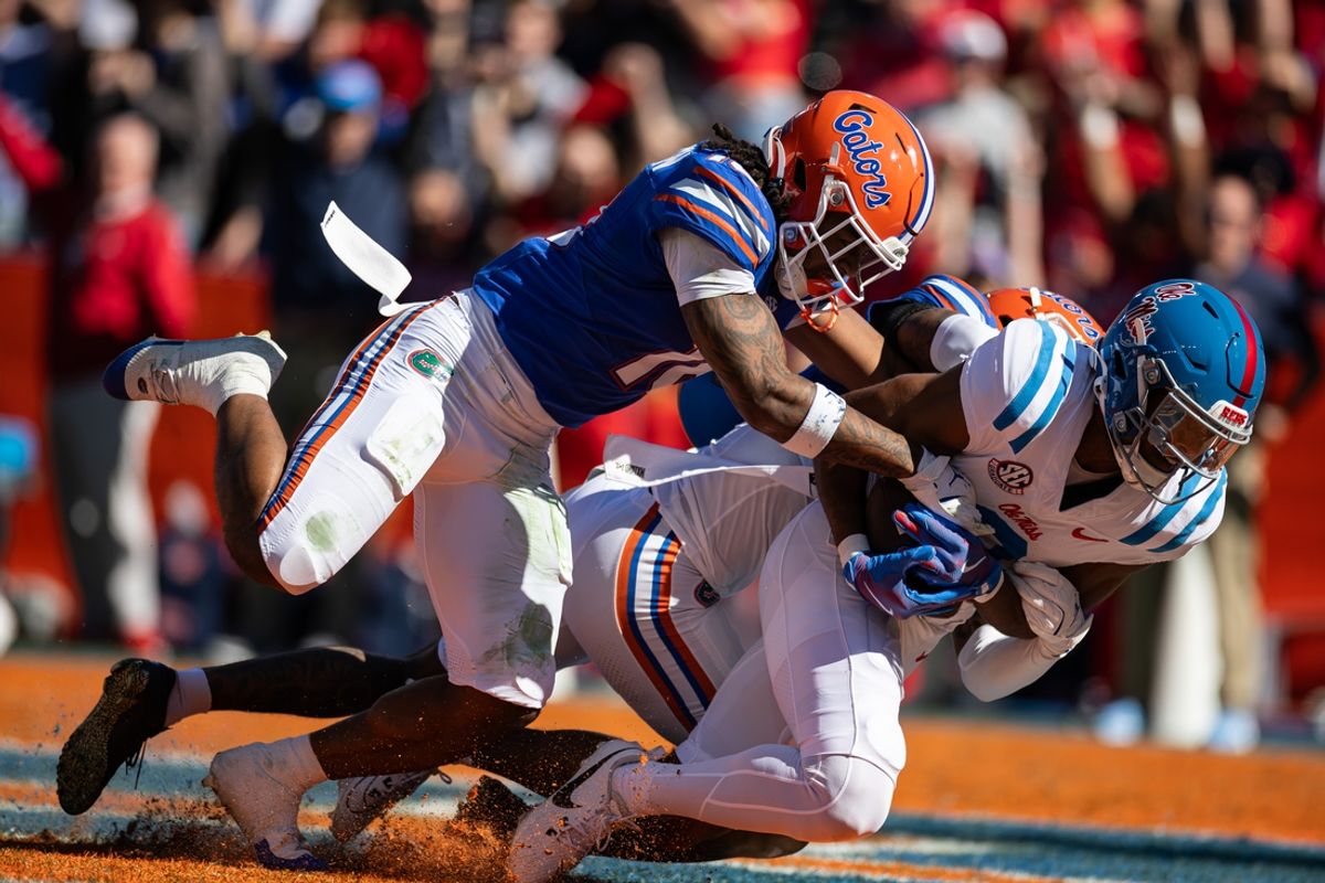 Nov 23, 2024; Gainesville, Florida, USA; Mississippi Rebels wide receiver Tre Harris (9) makes a catch for a touchdown over Florida Gators defensive back Bryce Thornton (18) during the first half at Ben Hill Griffin Stadium. Mandatory Credit: Matt Pendleton-Imagn Images
