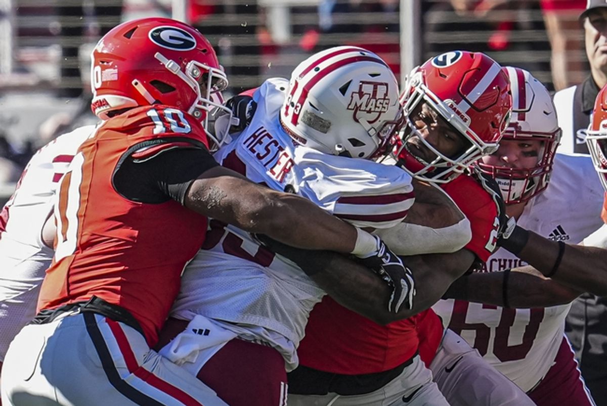 Nov 23, 2024; Athens, Georgia, USA; Georgia Bulldogs linebacker Damon Wilson II (10) and linebacker Smael Mondon Jr. (2) combine to tackle Massachusetts Minutemen running back CJ Hester (33) during the first quarter at Sanford Stadium. Mandatory Credit: Dale Zanine-Imagn Images