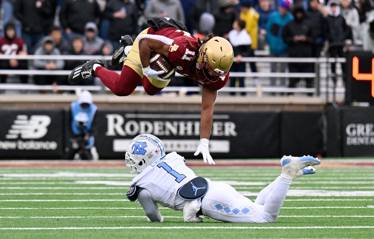 Nov 23, 2024; Chestnut Hill, Massachusetts, USA;  Boston College Eagles wide receiver Lewis Bond (11) leaps over North Carolina Tar Heels defensive back Antavious Lane (1) during the first half at Alumni Stadium. Mandatory Credit: Eric Canha-Imagn Images