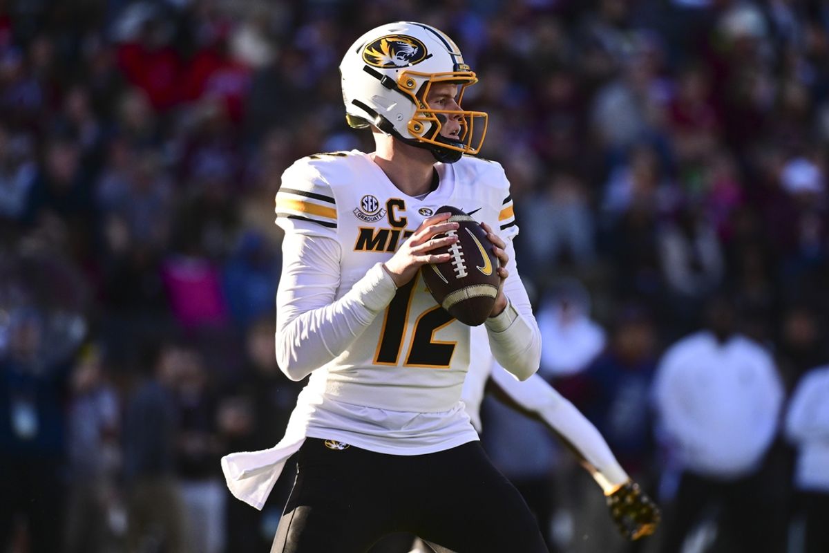 Nov 23, 2024; Starkville, Mississippi, USA; Missouri Tigers quarterback Brady Cook (12) drops to pass against the Mississippi State Bulldogs during the first quarter at Davis Wade Stadium at Scott Field. Mandatory Credit: Matt Bush-Imagn Images