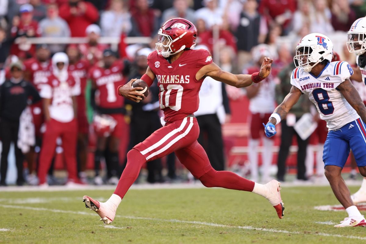 Nov 23, 2024; Fayetteville, Arkansas, USA; Arkansas Razorbacks quarterback Taylen Green (10) runs for a touchdown as Louisiana Tech Bulldogs defensive back Demarcus Griffin-Taylor (8) defends at Donald W. Reynolds Razorback Stadium. Mandatory Credit: Nelson Chenault-Imagn Images