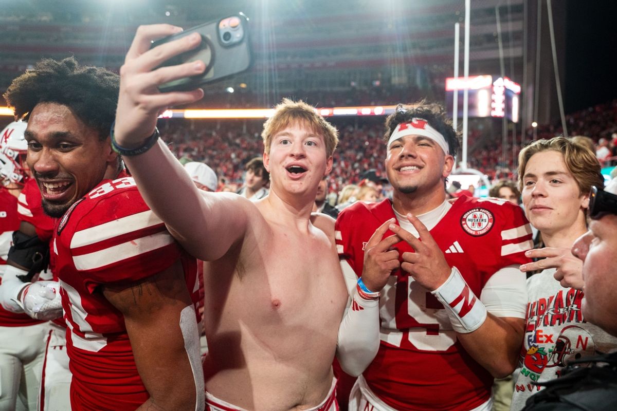 Nov 23, 2024; Lincoln, Nebraska, USA; Nebraska Cornhuskers quarterback Dylan Raiola (15) takes a picture with fans after defeating the Wisconsin Badgers at Memorial Stadium. Mandatory Credit: Dylan Widger-Imagn Images