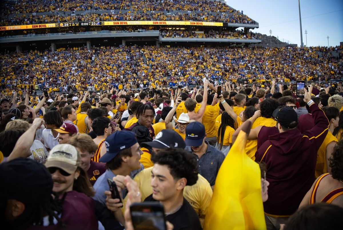 Nov 23, 2024; Tempe, Arizona, USA; Arizona State Sun Devils fans celebrate on the field in the closing second of the game against the Brigham Young Cougars at Mountain America Stadium. Mandatory Credit: Mark J. Rebilas-Imagn Images