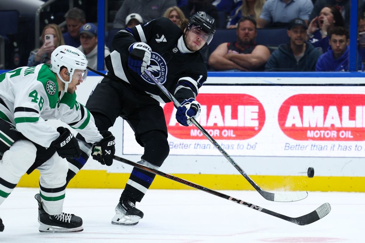 Nov 23, 2024; Tampa, Florida, USA; Tampa Bay Lightning center Conor Geekie (14) passes teh puck against the Dallas Stars in the first period at Amalie Arena. Mandatory Credit: Nathan Ray Seebeck-Imagn Images