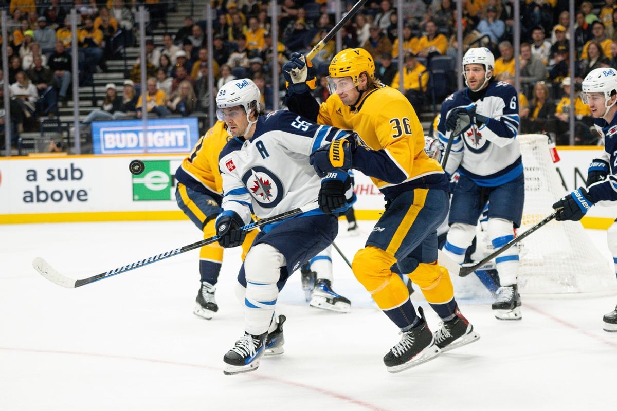 Nov 23, 2024; Nashville, Tennessee, USA;  Nashville Predators left wing Cole Smith (36) and Winnipeg Jets center Mark Scheifele (55) fight for the puck during the first period at Bridgestone Arena. Mandatory Credit: Steve Roberts-Imagn Images
