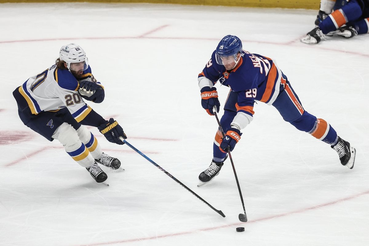 Nov 23, 2024; Elmont, New York, USA;  St. Louis Blues left wing Brandon Saad (20) and New York Islanders center Brock Nelson (29) battle for the puck in the first period at UBS Arena. Mandatory Credit: Wendell Cruz-Imagn Images