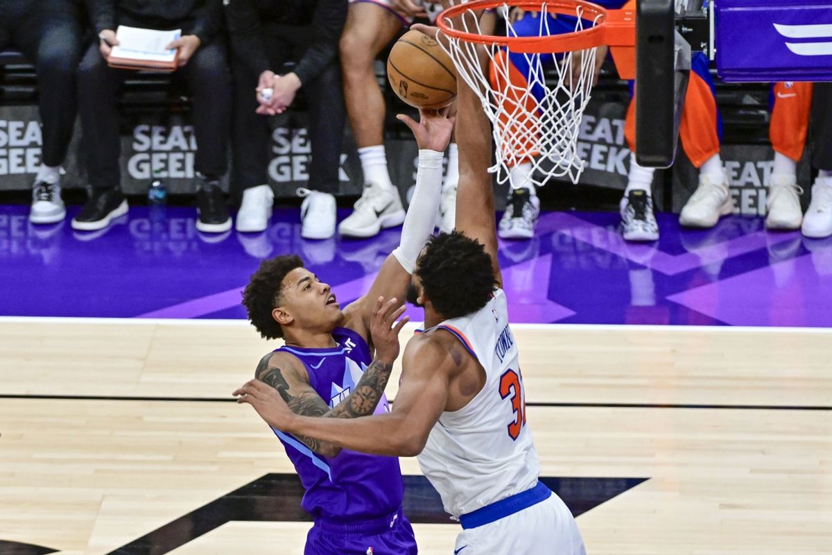Nov 23, 2024; Salt Lake City, Utah, USA; Utah Jazz guard Keyonte George (3) takes a layup shot over New York Knicks center/forward Karl-Anthony Towns (32) during the second half at the Delta Center. Mandatory Credit: Christopher Creveling-Imagn Images