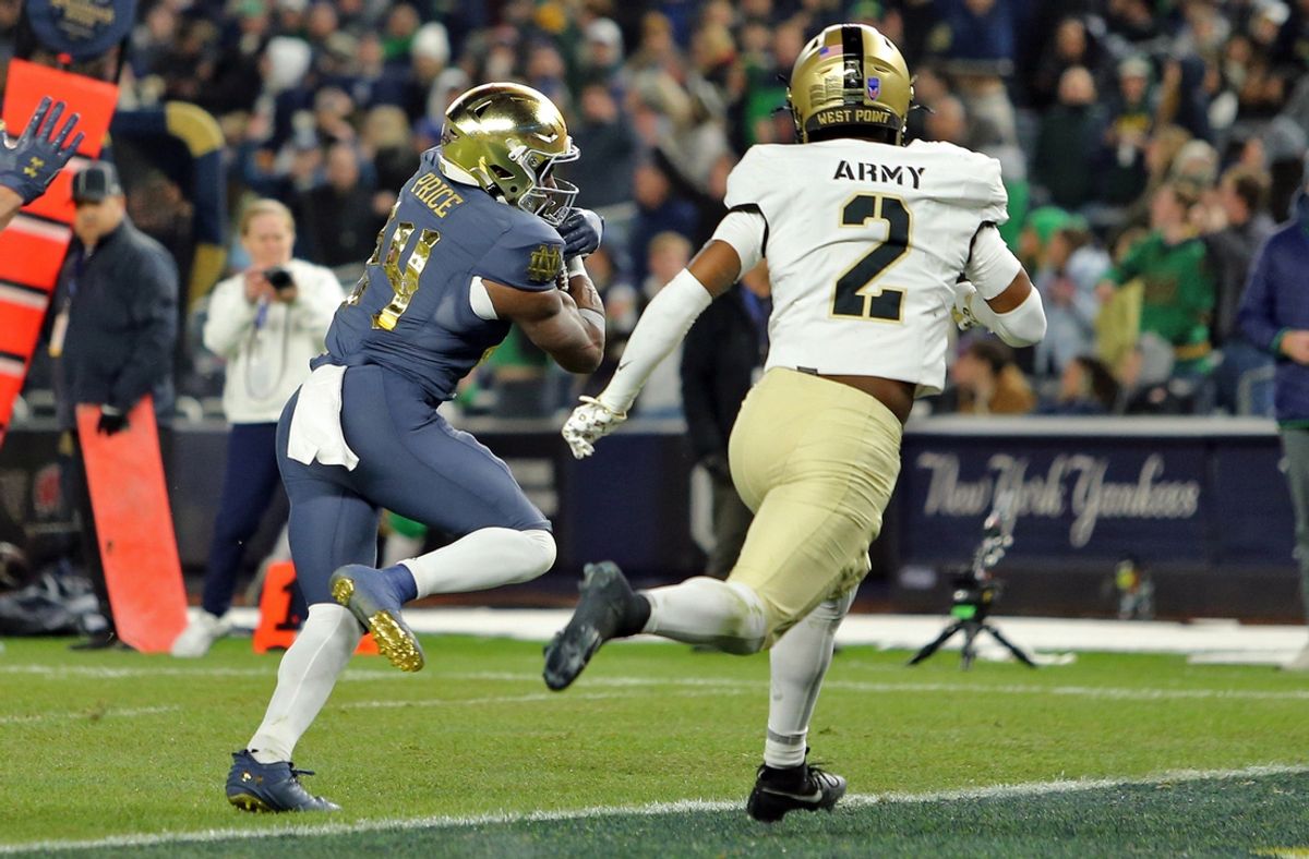 Nov 23, 2024; New York, New York, USA; Notre Dame Fighting Irish running back Jadarian Price (24) scores a touchdown in front of Army Black Knights defensive back Chance Keith (2) during the first half at Yankee Stadium. Mandatory Credit: Danny Wild-Imagn Images