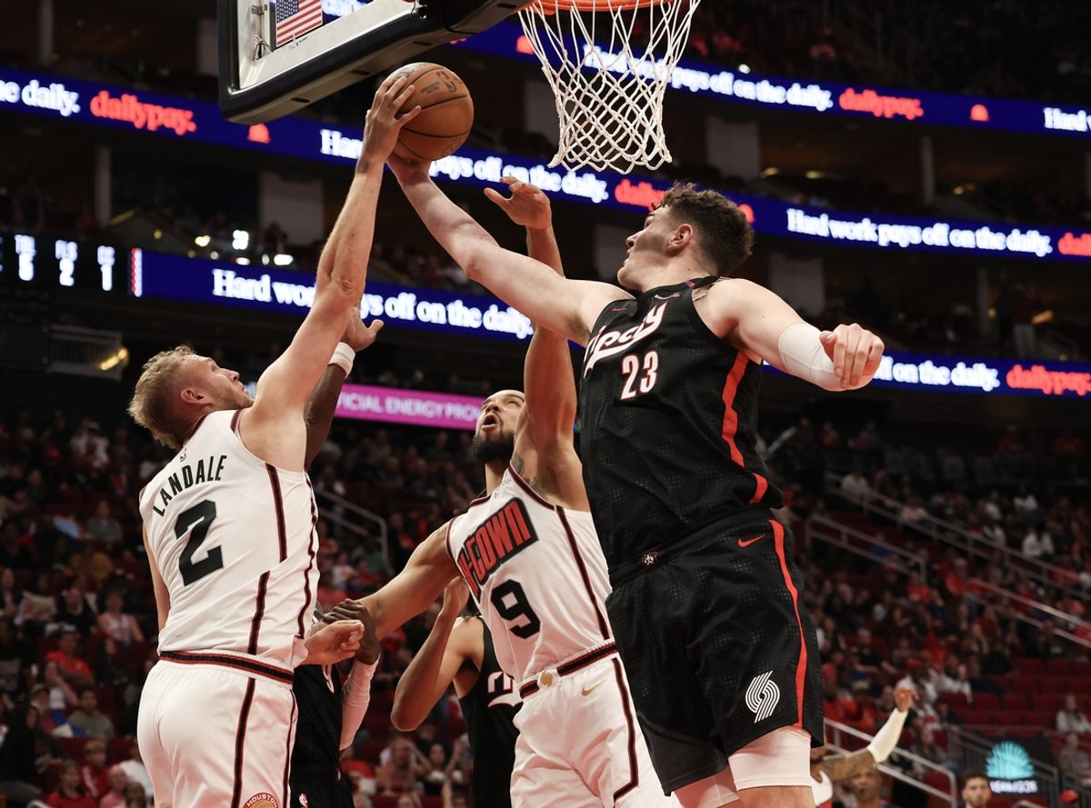 Nov 23, 2024; Houston, Texas, USA;  Portland Trail Blazers center Donovan Clingan (23) reaches for a defensive rebound against Houston Rockets center Jock Landale (2) in the second quarter at Toyota Center. Mandatory Credit: Thomas Shea-Imagn Images
