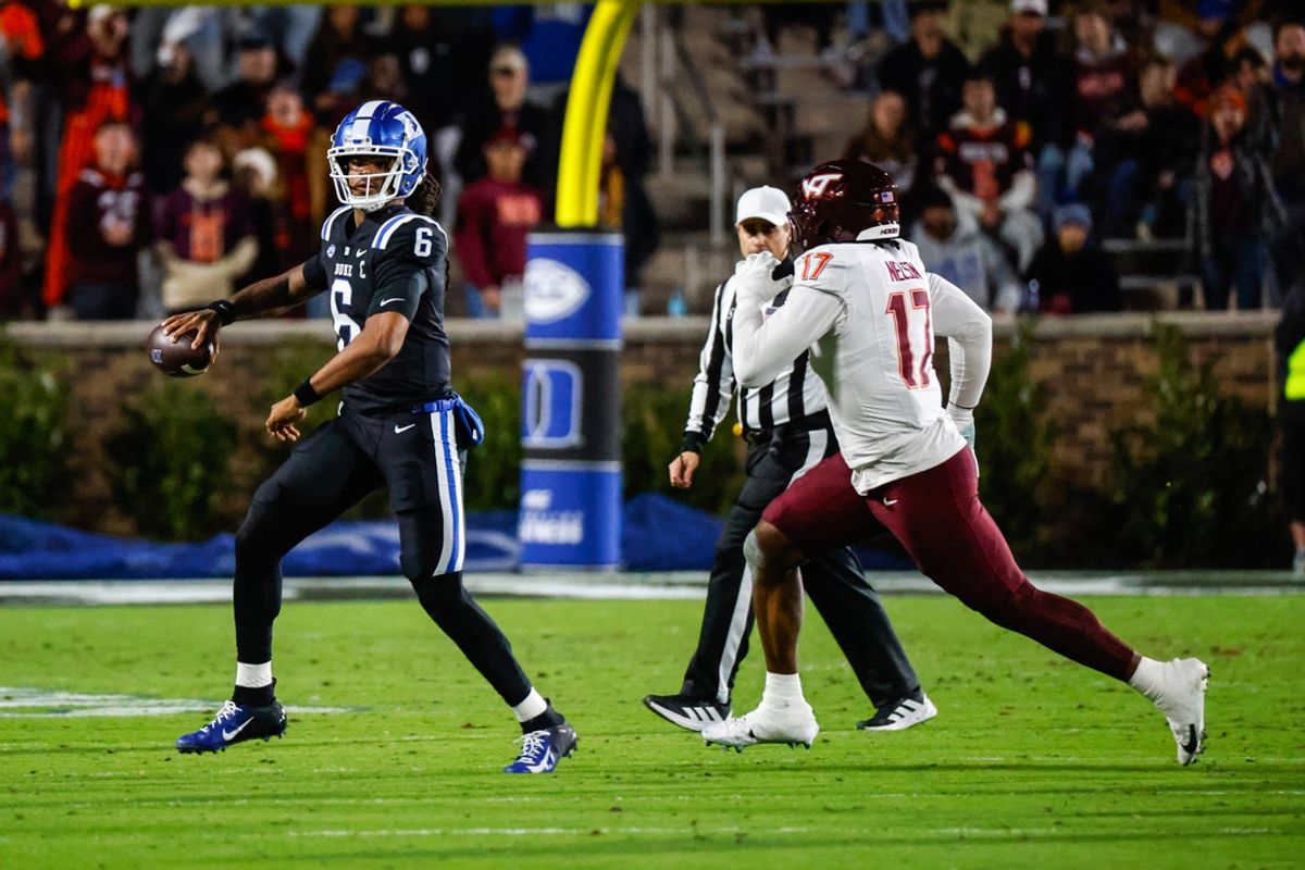 Nov 23, 2024; Durham, North Carolina, USA; Duke Blue Devils quarterback Maalik Murphy (6) runs with the football against Virginia Tech Hokies defensive lineman Cole Nelson (17) during the first half of the game at Wallace Wade Stadium. Mandatory Credit: Jaylynn Nash-Imagn Images