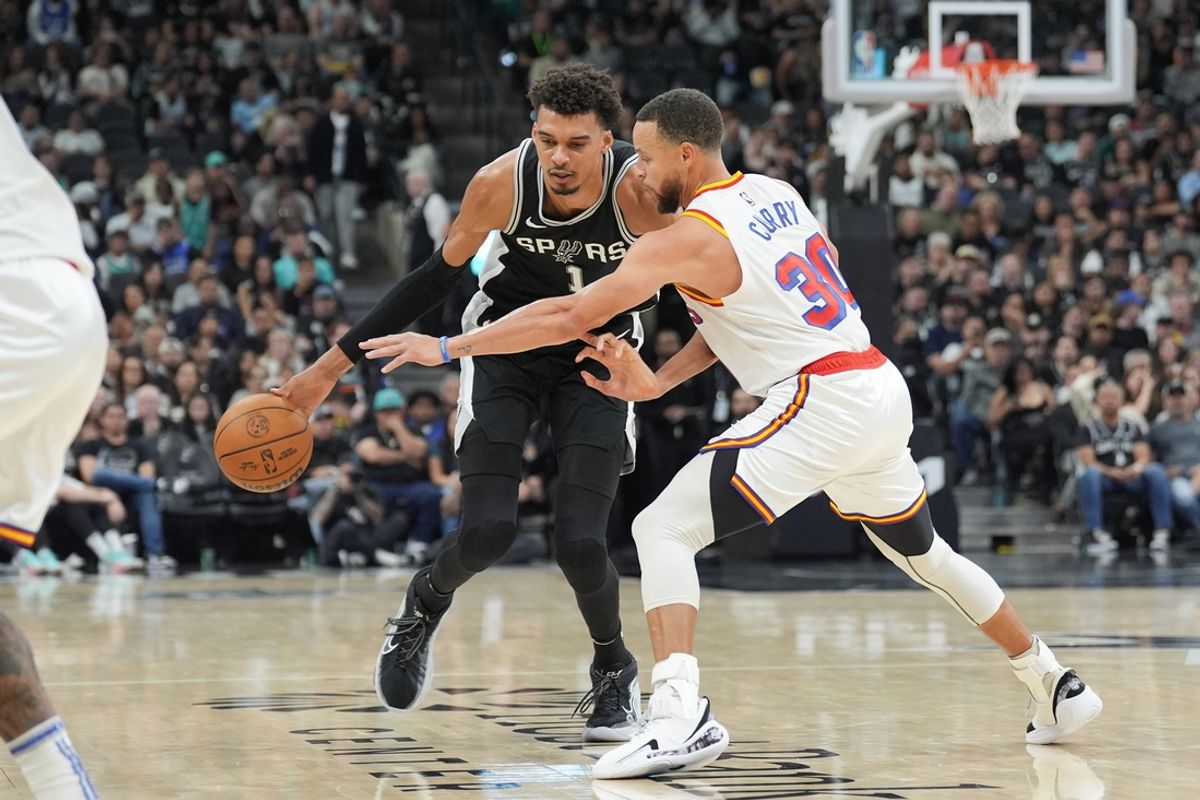 Nov 23, 2024; San Antonio, Texas, USA;  San Antonio Spurs center Victor Wembanyama (1) dribbles against Golden State Warriors guard Stephen Curry (30) in the first half at Frost Bank Center. Mandatory Credit: Daniel Dunn-Imagn Images