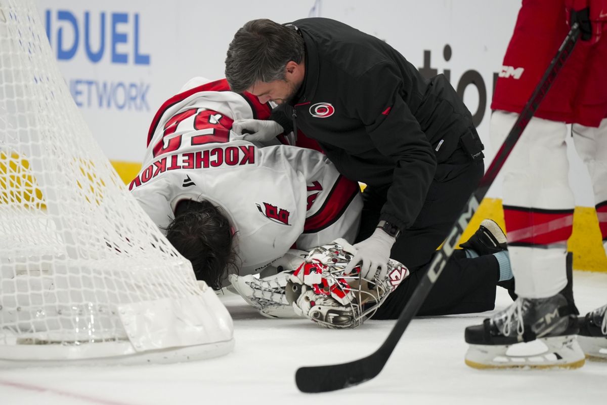 Nov 23, 2024; Columbus, Ohio, USA;  Carolina Hurricanes goaltender Pyotr Kochetkov (52) is tended to by the Hurricanes’ head athletic trainer Doug Bennett during a stop in play in the game against the Columbus Blue Jackets in the overtime period at Nationwide Arena. Mandatory Credit: Aaron Doster-Imagn Images