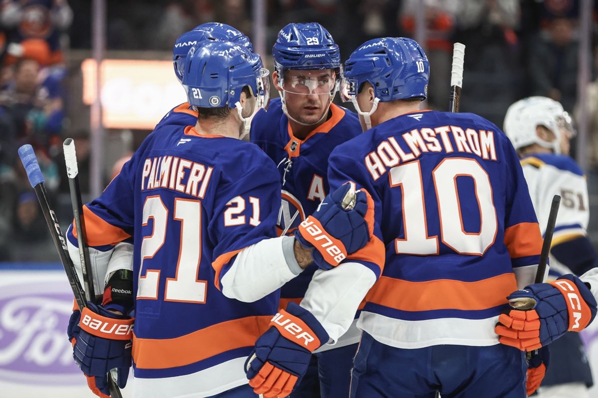Nov 23, 2024; Elmont, New York, USA;  New York Islanders center Brock Nelson (29) celebrates with center Kyle Palmieri (21) and right wing Simon Holmstrom (10) after scoring a goal in the second period against the St. Louis Blues at UBS Arena. Mandatory Credit: Wendell Cruz-Imagn Images