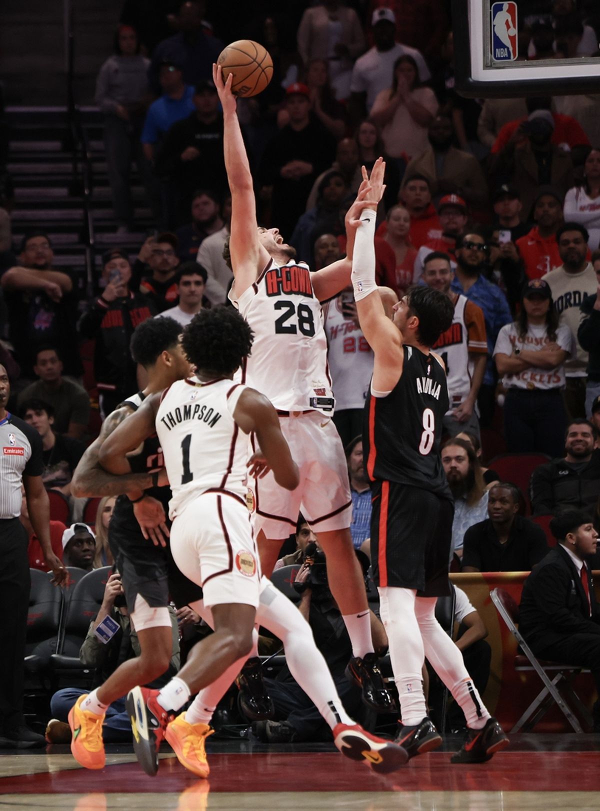 Nov 23, 2024; Houston, Texas, USA; Houston Rockets center Alperen Sengun (28) makes a basket against Portland Trail Blazers forward Deni Avdija (8) in the second half at Toyota Center. Mandatory Credit: Thomas Shea-Imagn Images