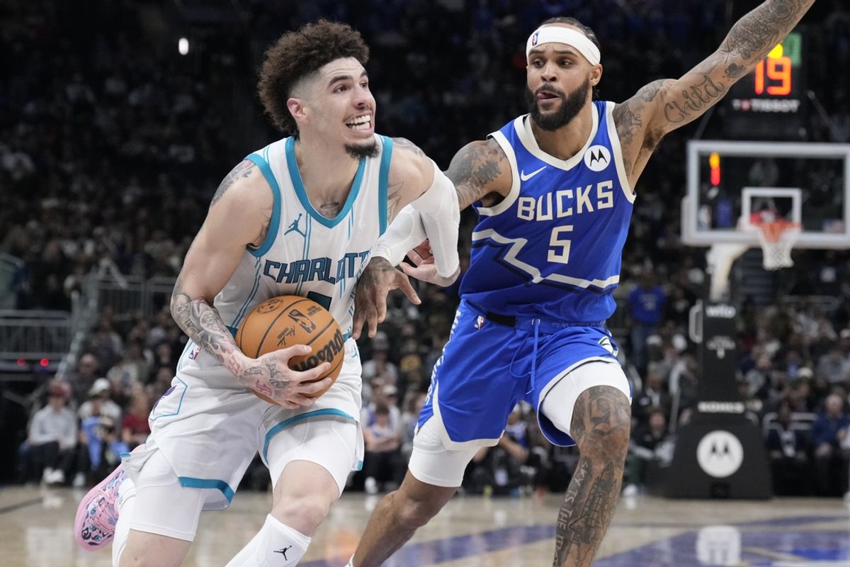 Nov 23, 2024; Milwaukee, Wisconsin, USA; Charlotte Hornets guard LaMelo Ball (1) drives to the basket against Milwaukee Bucks guard Gary Trent Jr. (5) in the second half at Fiserv Forum. Mandatory Credit: Michael McLoone-Imagn Images