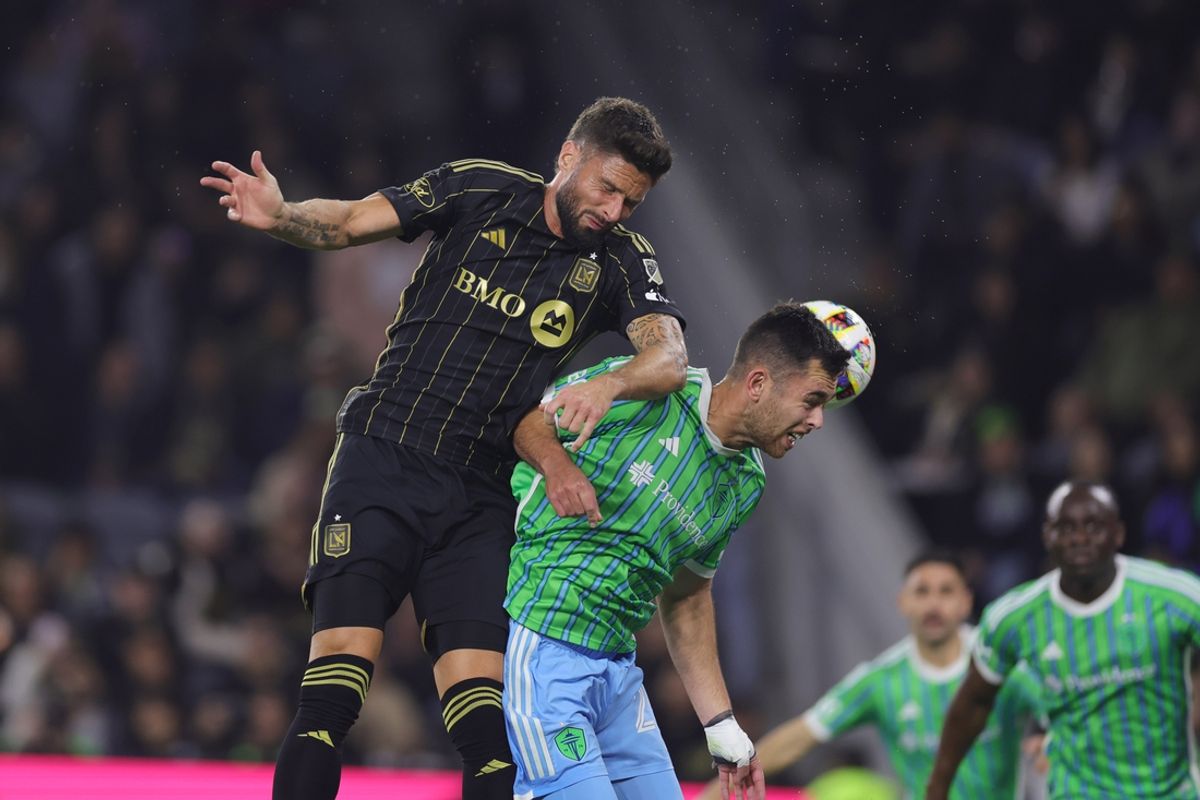 Nov 23, 2024; Los Angeles, California, USA; Seattle Sounders FC defender Jackson Ragen (25) heads the ball against LAFC forward Olivier Giroud (9) in the first half in a 2024 MLS Cup western conference semifinal match at BMO Stadium. Mandatory Credit: Ryan Sun-Imagn Images