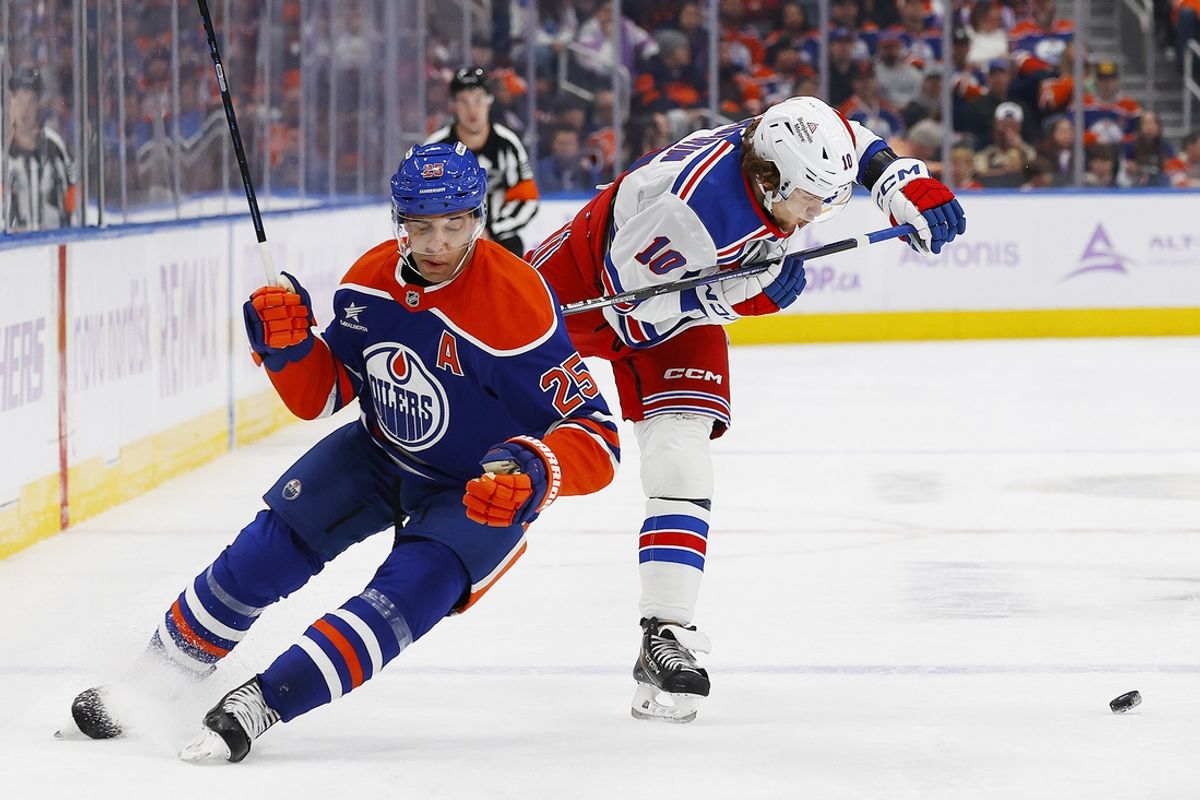 Nov 23, 2024; Edmonton, Alberta, CAN; Edmonton Oilers defensemen Darnell Nurse (25) checks New York Rangers forward Artemi Panarin (10) during the second period at Rogers Place. Mandatory Credit: Perry Nelson-Imagn Images