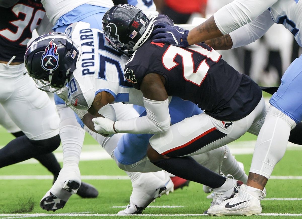 Nov 24, 2024; Houston, Texas, USA; Tennessee Titans running back Joshua Kelley (25) is tackled by Houston Texans safety Jimmie Ward (20) in the first quarter at NRG Stadium. Mandatory Credit: Thomas Shea-Imagn Images