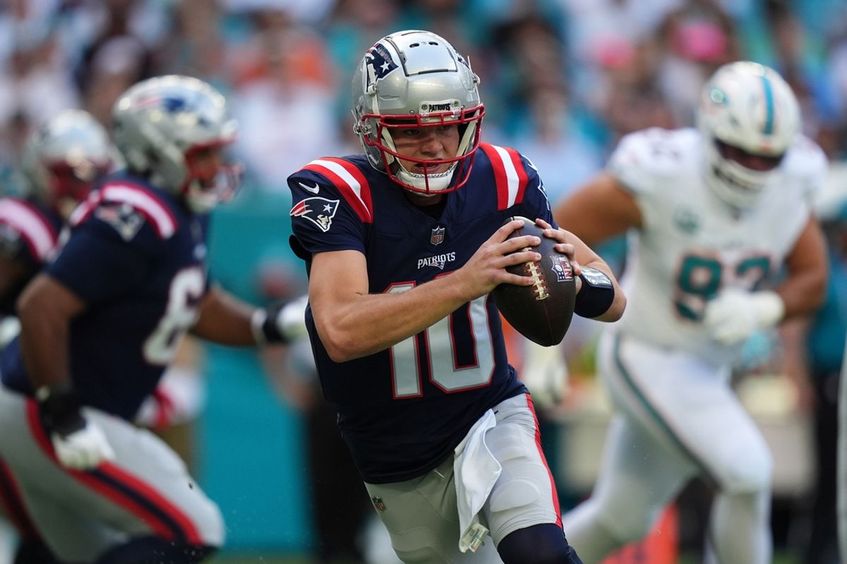 Nov 24, 2024; Miami Gardens, Florida, USA; New England Patriots quarterback Drake Maye (10) scrambles with the ball against the Miami Dolphins during the first half at Hard Rock Stadium. Mandatory Credit: Jasen Vinlove-Imagn Images