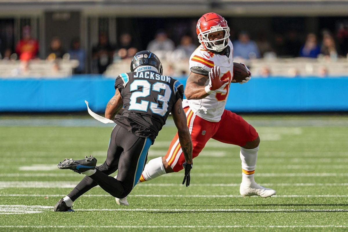 Nov 24, 2024; Charlotte, North Carolina, USA; Kansas City Chiefs running back Samaje Perine (34) runs around end chased by Carolina Panthers cornerback Dane Jackson (23) during the second quarter at Bank of America Stadium. Mandatory Credit: Jim Dedmon-Imagn Images