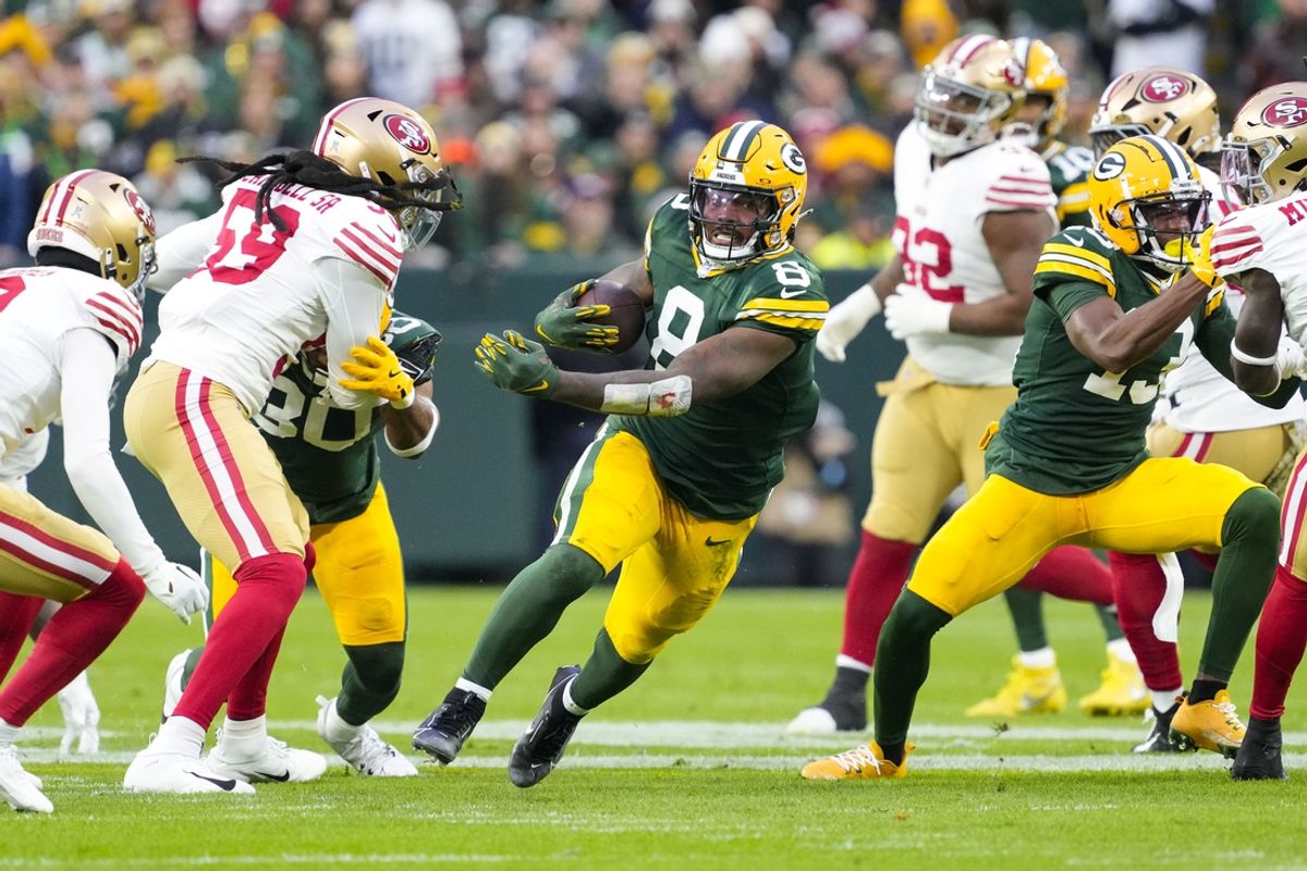 Nov 24, 2024; Green Bay, Wisconsin, USA;  Green Bay Packers running back Josh Jacobs (8) rushes with the football during the first quarter against the San Francisco 49ers at Lambeau Field. Mandatory Credit: Jeff Hanisch-Imagn Images