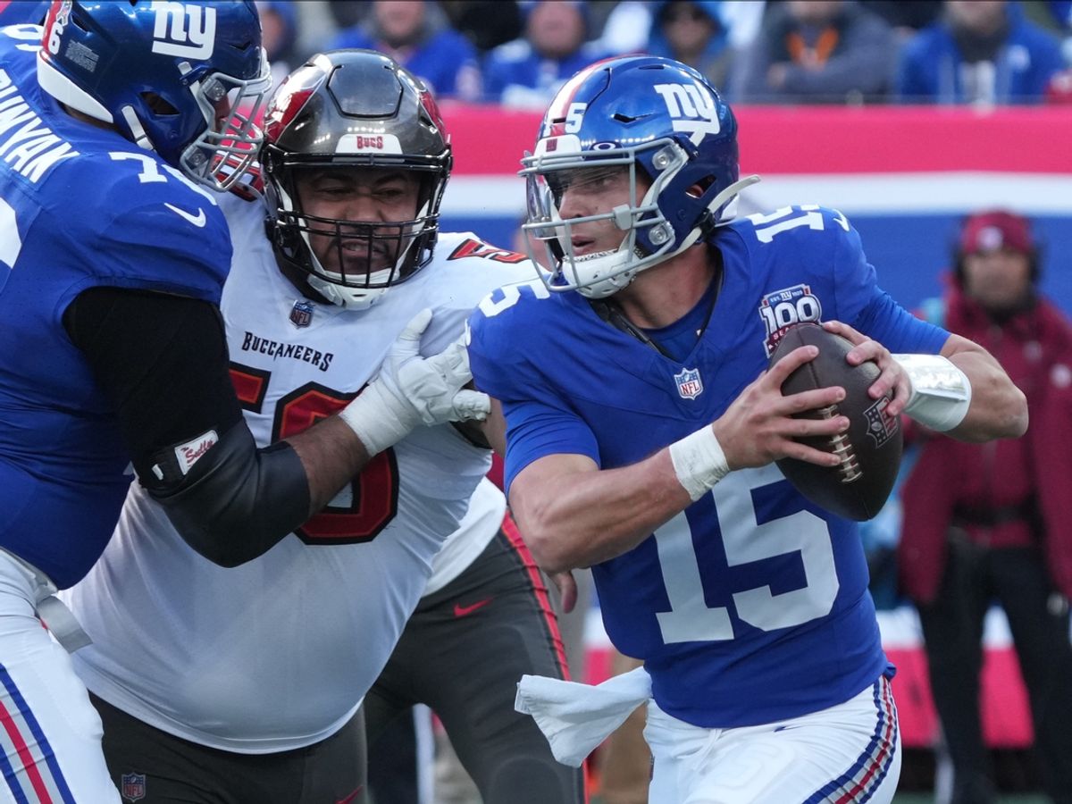 East Rutherford, NJ -- November 24, 2024 -- Vita Vea of Tampa Bay chases Tommy DeVito of the Giants in the first half as the Tampa Bay Buccaneers came to MetLife Stadium to play the New York Giants.