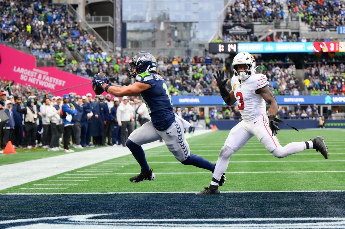 Nov 24, 2024; Seattle, Washington, USA; Seattle Seahawks wide receiver Jaxon Smith-Njigba (11) scores a touchdown while defended by Arizona Cardinals safety Budda Baker (3) during the first half at Lumen Field. Mandatory Credit: Steven Bisig-Imagn Images