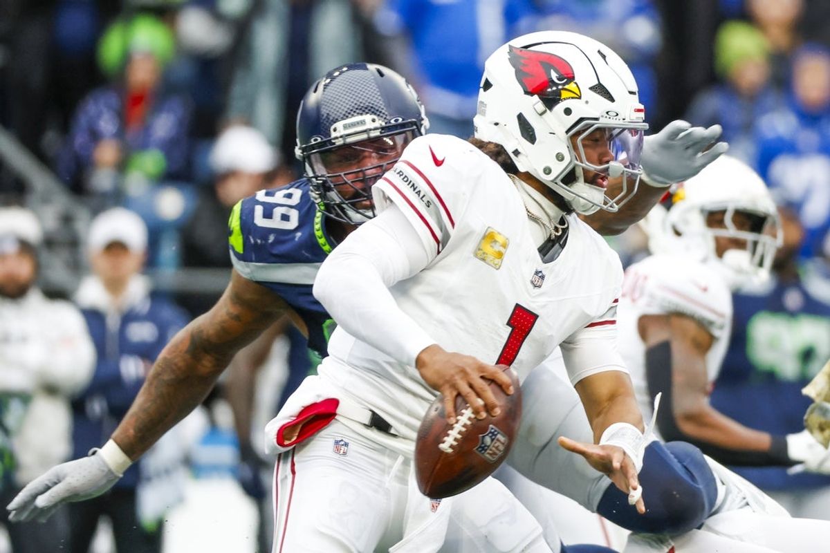 Nov 24, 2024; Seattle, Washington, USA; Arizona Cardinals quarterback Kyler Murray (1) escapes a sack attempt by Seattle Seahawks defensive end Leonard Williams (99) during the second quarter at Lumen Field. Mandatory Credit: Joe Nicholson-Imagn Images