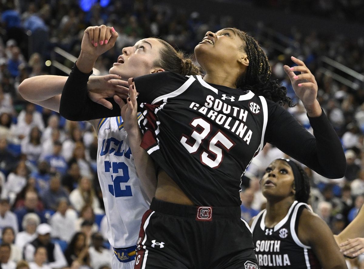 Nov 24, 2024; Los Angeles, California, USA; South Carolina Gamecocks center Sakima Walker (35) and UCLA Bruins forward Angela Dugalic (32) jockey for rebounding position during the fourth quarter at Pauley Pavilion presented by Wescom. Mandatory Credit: Robert Hanashiro-Imagn Images