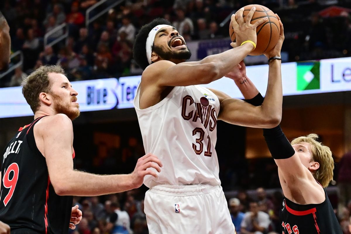 Nov 24, 2024; Cleveland, Ohio, USA; Cleveland Cavaliers center Jarrett Allen (31) drives to the basket between Toronto Raptors center Jakob Poeltl (19) and guard Gradey Dick (1) during the first half at Rocket Mortgage FieldHouse. Mandatory Credit: Ken Blaze-Imagn Images