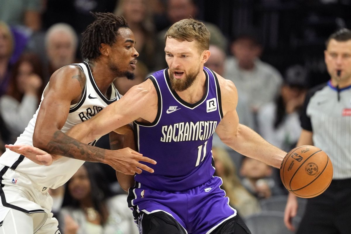 Nov 24, 2024; Sacramento, California, USA; Sacramento Kings forward Domantas Sabonis (11) dribbles against Brooklyn Nets center Nic Claxton (left) during the second quarter at Golden 1 Center. Mandatory Credit: Darren Yamashita-Imagn Images