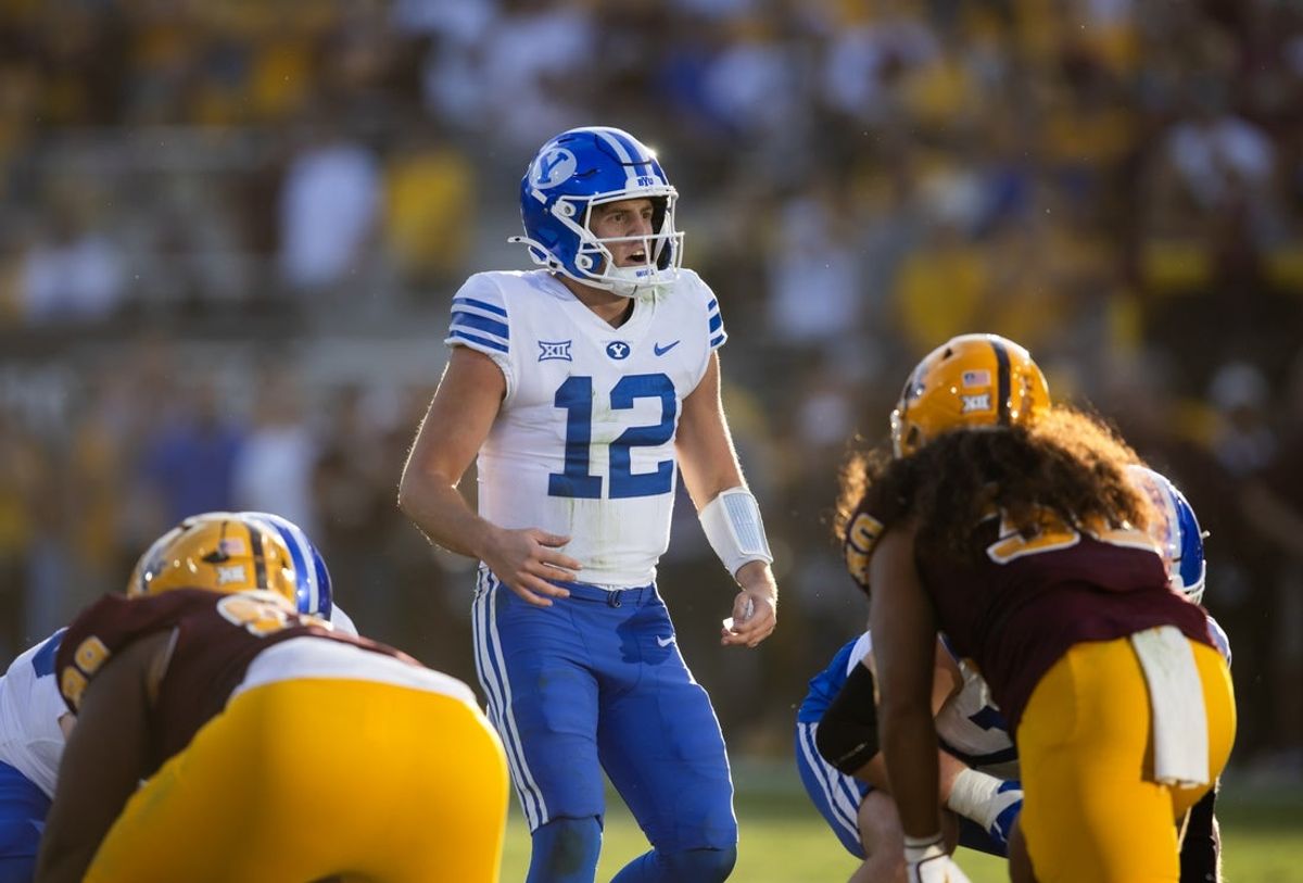 Nov 23, 2024; Tempe, Arizona, USA; Brigham Young Cougars quarterback Jake Retzlaff (12) against the Arizona State Sun Devils at Mountain America Stadium. Mandatory Credit: Mark J. Rebilas-Imagn Images