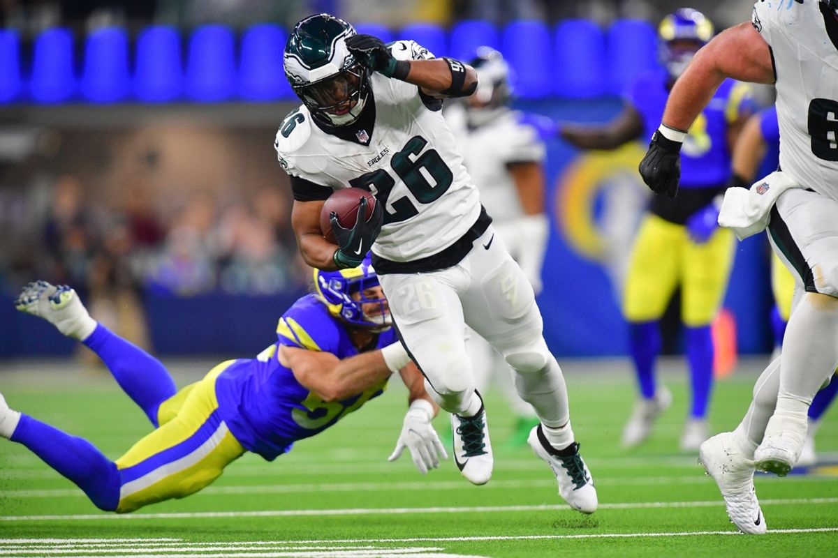 Nov 24, 2024; Inglewood, California, USA; Philadelphia Eagles running back Saquon Barkley (26) runs the ball ahead of Los Angeles Rams linebacker Christian Rozeboom (56) during the second half at SoFi Stadium. Mandatory Credit: Gary A. Vasquez-Imagn Images