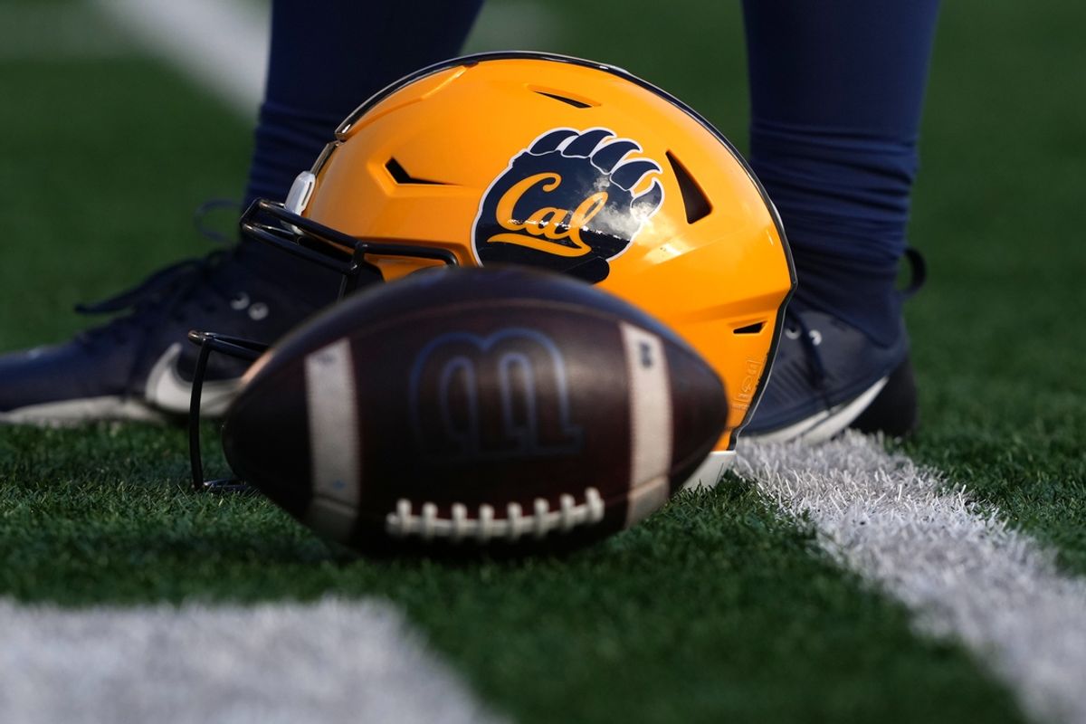 Nov 23, 2024; Berkeley, California, USA; The helmet of California Golden Bears long snapper Ewan Arechaederra (48) sits on the field with a ball before the game against the Stanford Cardinal at California Memorial Stadium. Mandatory Credit: Darren Yamashita-Imagn Images