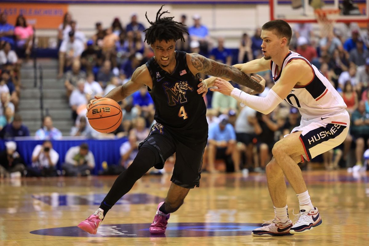 Nov 25, 2024; Lahaina, Hawaii, USA;  Memphis Tigers forward Tyreek Smith (5) tries to dribble past Connecticut Huskies guard Aidan Mahaney (20) during the first half of an NCAA college basketball game at Lahaina Civic Center. Mandatory Credit: Marco Garcia-Imagn Images
