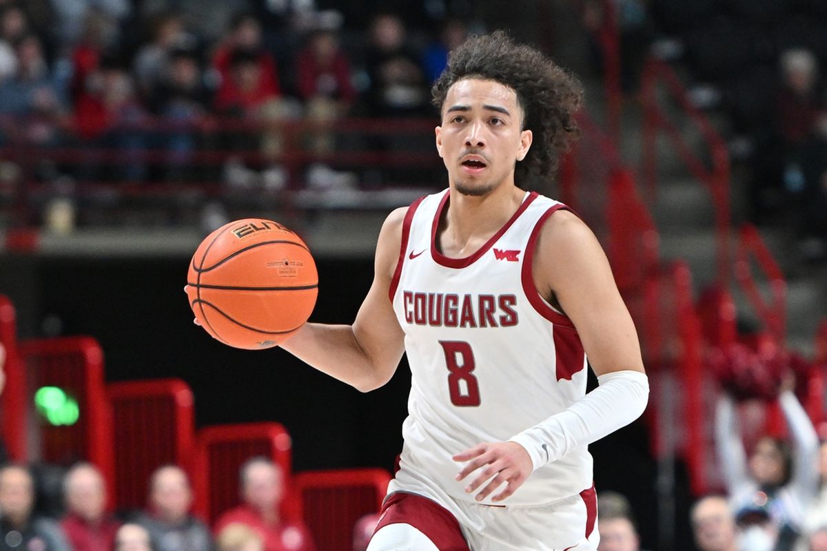 Nov 21, 2024; Spokane, Washington, USA; Washington State Cougars guard Nate Calmese (8) controls the ball against the Eastern Washington Eagles in the first half at Spokane Veterans Memorial Arena. Mandatory Credit: James Snook-Imagn Images