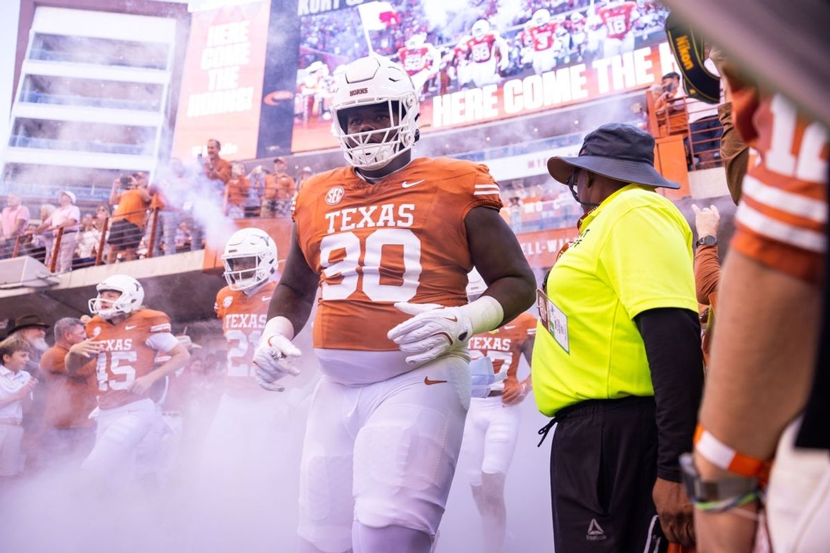 Nov 23, 2024; Austin, Texas, USA; Texas Longhorns nose tackle Sydir Mitchell (90) runs out of the tunnel against the Kentucky Wildcats at Darrell K Royal-Texas Memorial Stadium. Mandatory Credit: Brett Patzke-Imagn Images