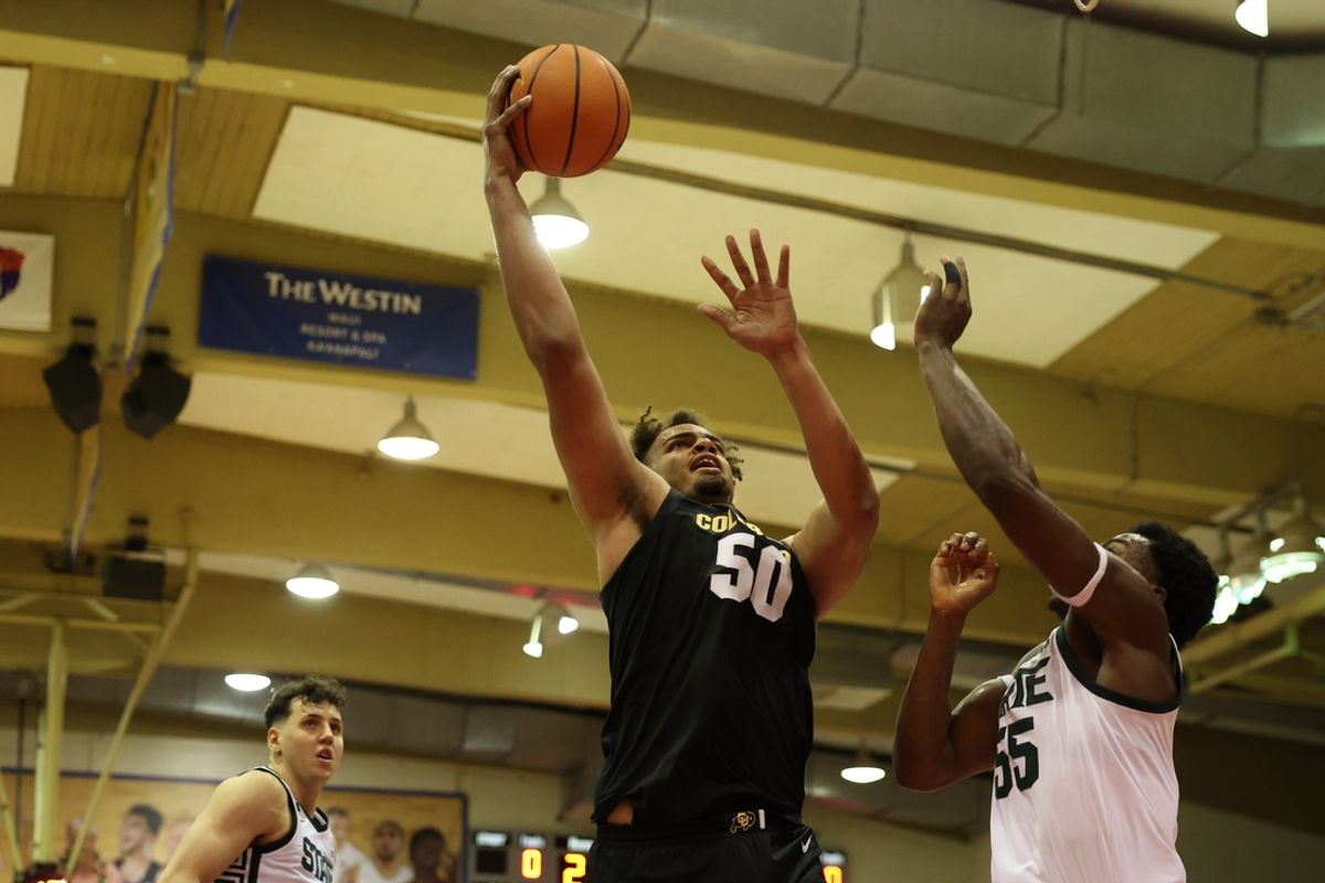Nov 25, 2024; Lahaina, Hawaii, USA;  Colorado Buffaloes center Elijah Malone (50) shoots over Michigan State Spartans forward Coen Carr (55) goes for the net over /i55/ at Lahaina Civic Center. Mandatory Credit: Marco Garcia-Imagn Images