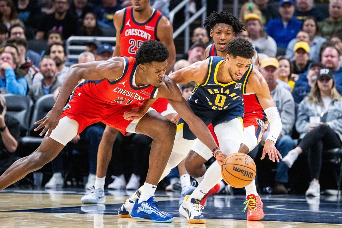 Nov 25, 2024; Indianapolis, Indiana, USA;  Indiana Pacers guard Tyrese Haliburton (0) and New Orleans Pelicans center Yves Missi (21) fight for the ball in the first half at Gainbridge Fieldhouse. Mandatory Credit: Trevor Ruszkowski-Imagn Images