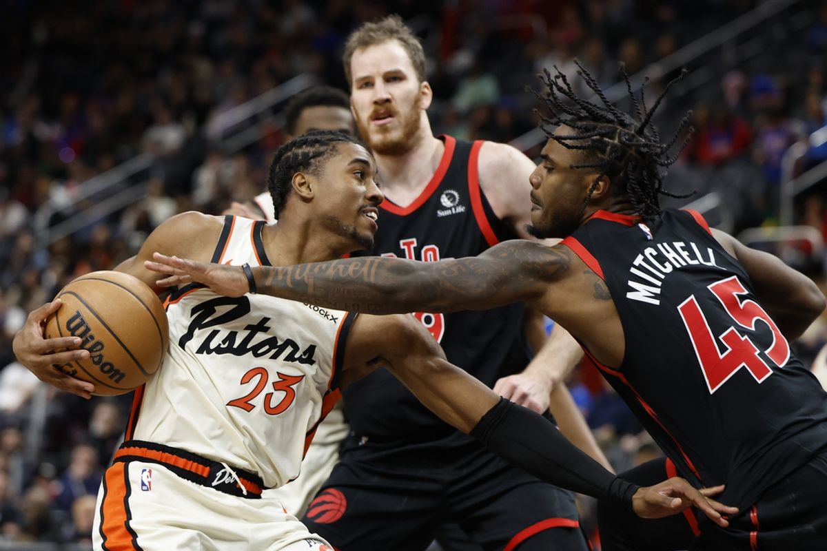 Nov 25, 2024; Detroit, Michigan, USA;  Detroit Pistons guard Jaden Ivey (23) is defended by Toronto Raptors center Jakob Poeltl (19) and guard Davion Mitchell (45) in the first half at Little Caesars Arena. Mandatory Credit: Rick Osentoski-Imagn Images