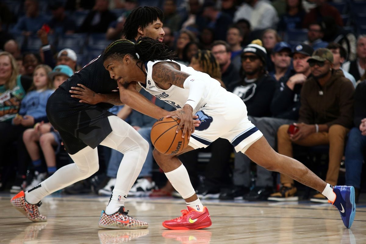 Nov 25, 2024; Memphis, Tennessee, USA; Memphis Grizzlies guard Ja Morant (12) drives the ball up the court as Portland Trail Blazers guard Shaedon Sharpe (17) defends during the first half at FedExForum. Mandatory Credit: Petre Thomas-Imagn Images