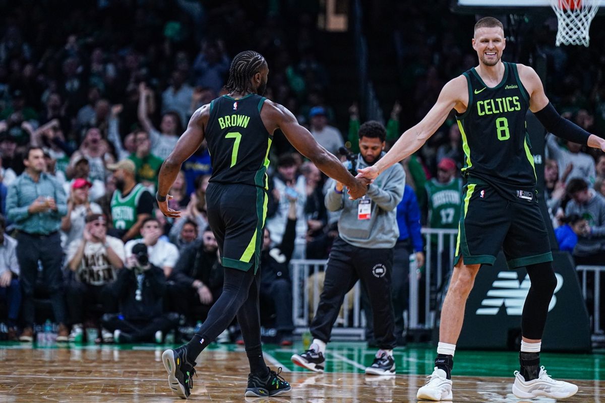 Nov 25, 2024; Boston, Massachusetts, USA; Boston Celtics guard Jaylen Brown (7) reacts with center Kristaps Porzingis (8) after his three point basket against the LA Clippers in the second quarter at TD Garden. Mandatory Credit: David Butler II-Imagn Images
