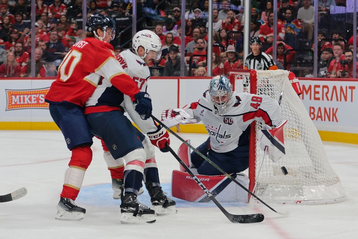 Nov 25, 2024; Sunrise, Florida, USA; Washington Capitals goaltender Logan Thompson (48) and defenseman Trevor van Riemsdyk (57) defend against Florida Panthers center Jesper Boqvist (70) during the second period at Amerant Bank Arena. Mandatory Credit: Sam Navarro-Imagn Images