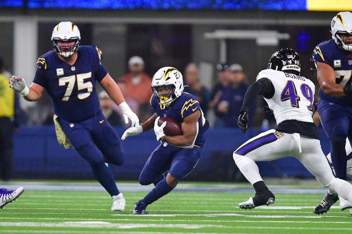 Nov 25, 2024; Inglewood, California, USA; Los Angeles Chargers running back J.K. Dobbins (27) runs the ball against the Baltimore Ravens during the first half at SoFi Stadium. Mandatory Credit: Gary A. Vasquez-Imagn Images