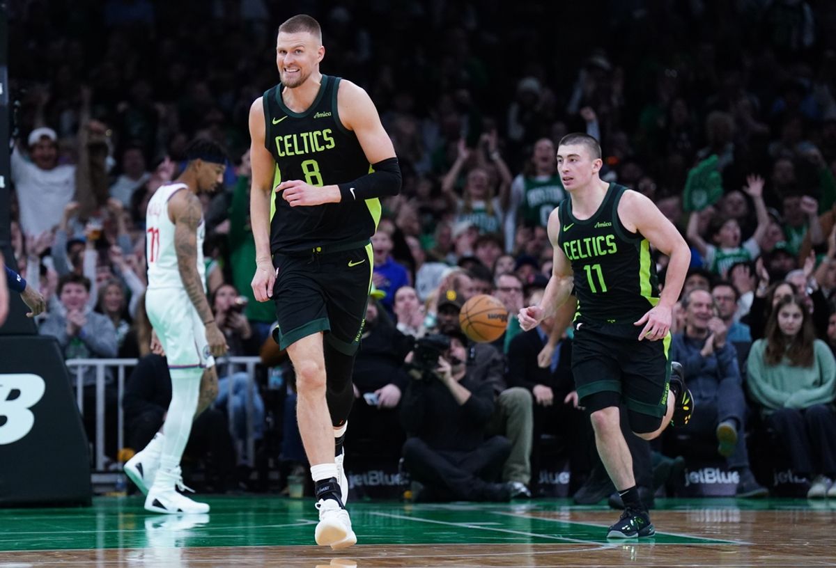 Nov 25, 2024; Boston, Massachusetts, USA; Boston Celtics center Kristaps Porzingis (8) reacts after his basket with help from guard Payton Pritchard (11) against the LA Clippers in the second half at TD Garden. Mandatory Credit: David Butler II-Imagn Images
