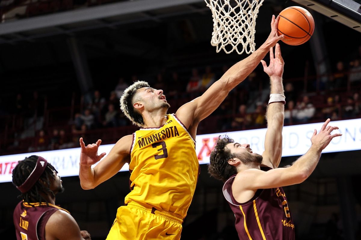 Nov 25, 2024; Minneapolis, Minnesota, USA; Minnesota Golden Gophers forward Dawson Garcia (3) blocks a shot by Central Michigan Chippewas guard Cayden Vasko (2) during the second half at Williams Arena. Mandatory Credit: Matt Krohn-Imagn Images