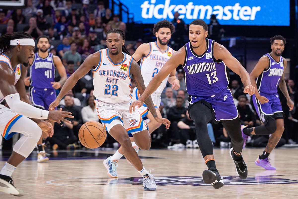 Nov 25, 2024; Sacramento, California, USA; Oklahoma City Thunder guards Luguentz Dort (5) and Cason Wallace (22) attempt to control the ball against Sacramento Kings forward Keegan Murray (13) during the second quarter at Golden 1 Center. Mandatory Credit: Ed Szczepanski-Imagn Images
